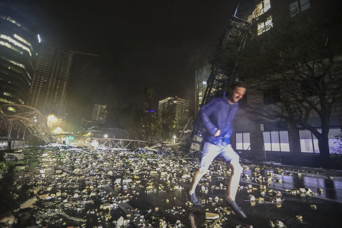 Joe Lindquist, 32, of St. Petersburg, walks over bricks near a fallen crane along 1st Avenue South near the Tampa Bay Times offices in St. Petersburg, Florida, Thursday, October 10, 2024, as Hurricane Milton's strong winds tore through the area. Picture: Chris Urso/Tampa Bay Times via AP Joe Lindquist, 32, of St. Petersburg, walks over bricks near a fallen crane along 1st Avenue South near the Tampa Bay Times offices in St. Petersburg, Florida, Thursday, October 10, 2024, as Hurricane Milton's strong winds tore through the area. Picture: Chris Urso/Tampa Bay Times via AP