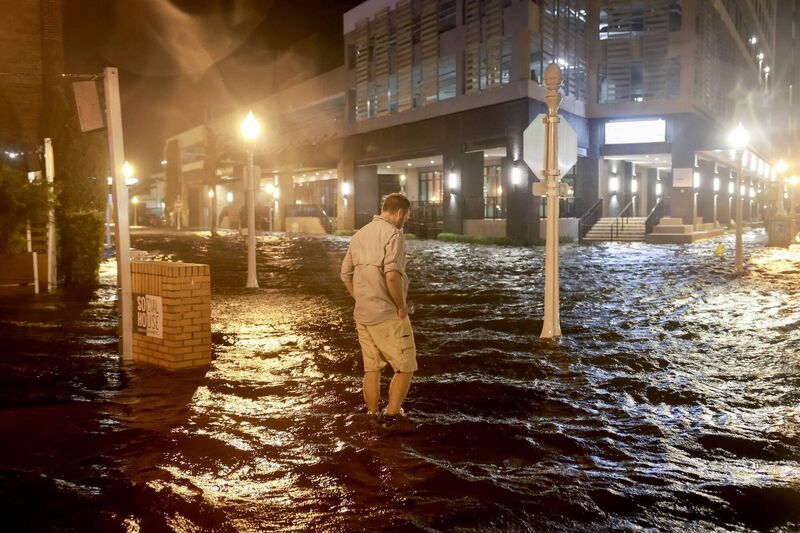 Brandon Marlow walks through surge waters flooding the street after Hurricane Milton came ashore in the Sarasota area on Wednesday. Photo: Joe Raedle/Getty Images Brandon Marlow walks through surge waters flooding the street after Hurricane Milton came ashore in the Sarasota area on Wednesday. Photo: Joe Raedle/Getty Images