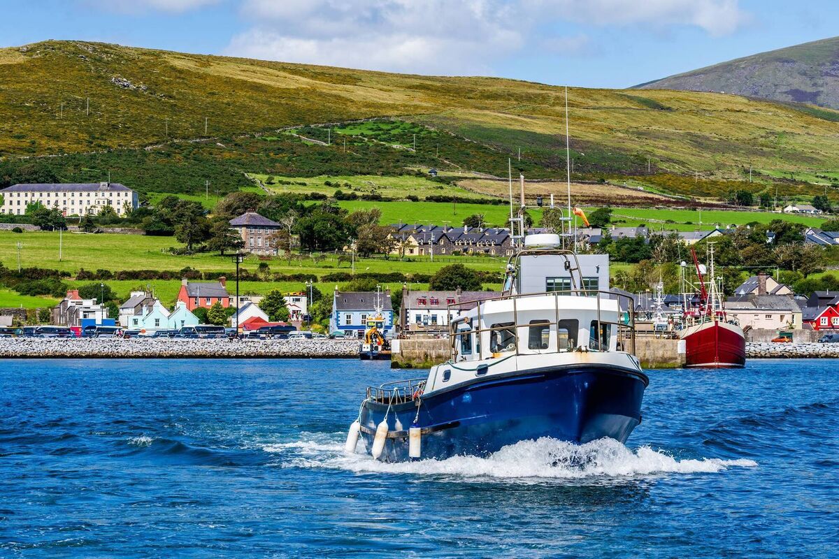 A boat tour, leaving Dingle harbour for sightseeing A boat tour, leaving Dingle harbour for sightseeing