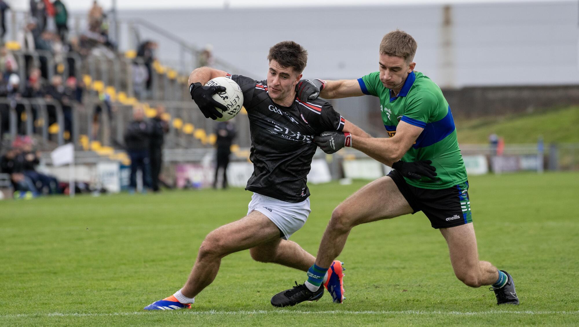 East Kerry's Donal O'Sullivan under pressure from Dingle's Conchuir O'Suilleabhain in Sunday's Kerry SFC semi-final in Tralee. Pic: Domnick Walsh