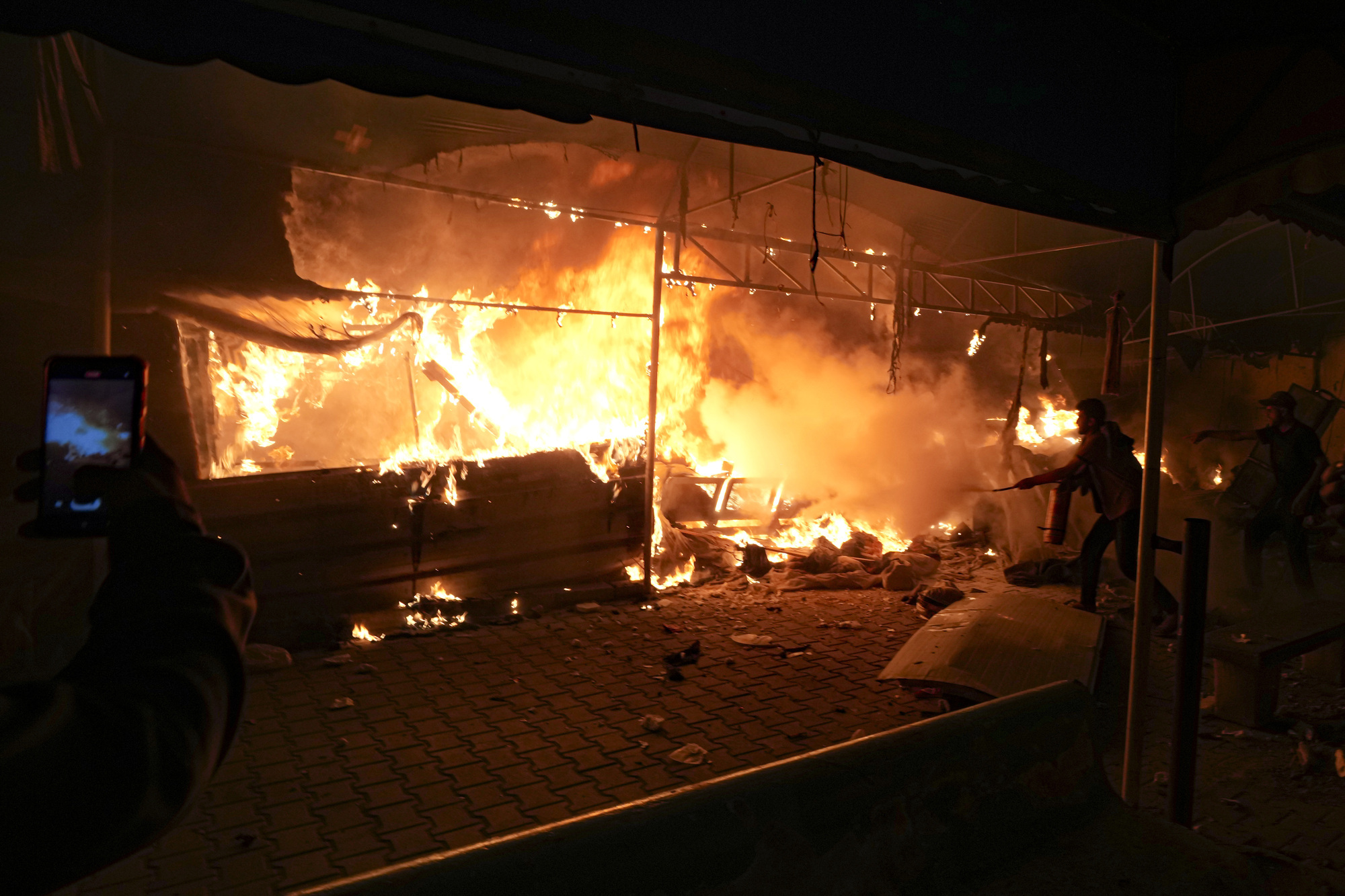 Israeli strike on hospital camp kills four, igniting fire that burns dozens