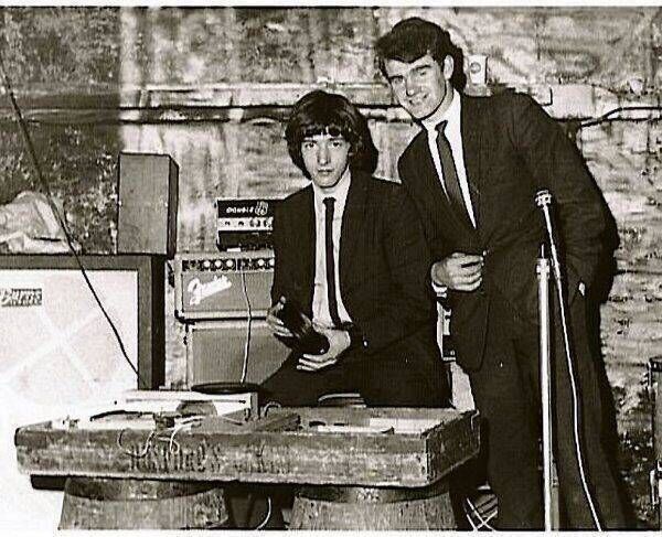 Rory’s brother Donal and a fellow Cavern club employee, Paul, behind the primitive record decks that were rigged up in a crate from Harrington’s bakery. Rory’s brother Donal and a fellow Cavern club employee, Paul, behind the primitive record decks that were rigged up in a crate from Harrington’s bakery.
