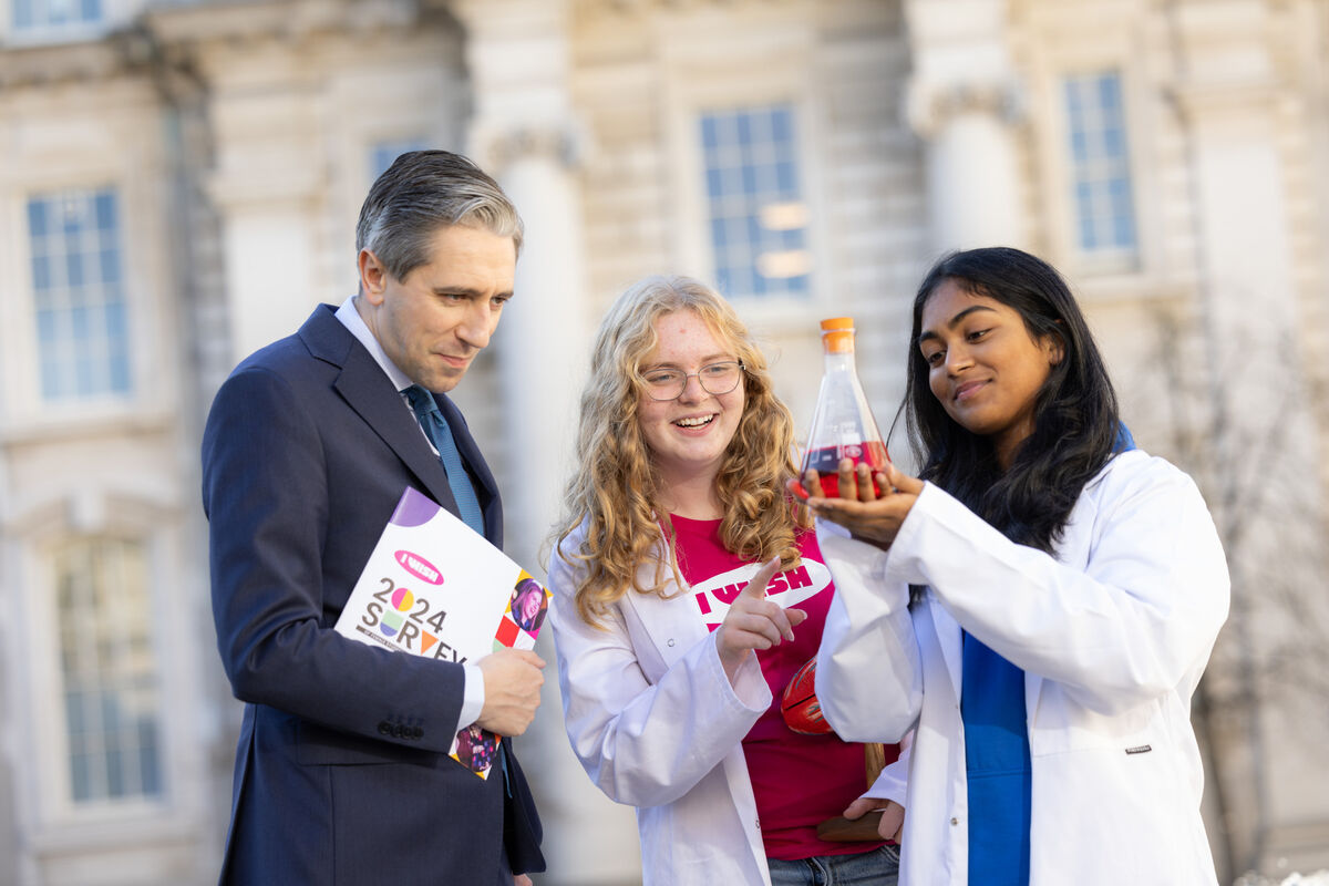  Taoiseach Simon Harris with transition year students Julianne Diskin and Jahnavi Reddy Tumma  at the launch of the 2024 I Wish Report. Picture: Naoise Culhane