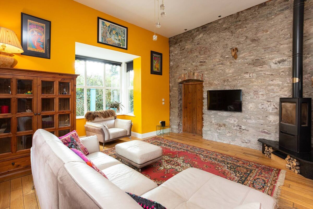 Feature stone wall in the main living area built using recycled stones from the original cottage