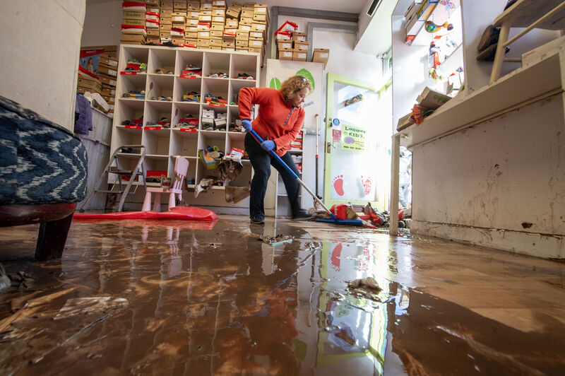 Eleanor Dunlea cleaning up at Lollipop Kids on Main St, Midleton, Co Cork, in October 2023 in the wake of the Storm Babet flooding. Picture: Dan Linehan