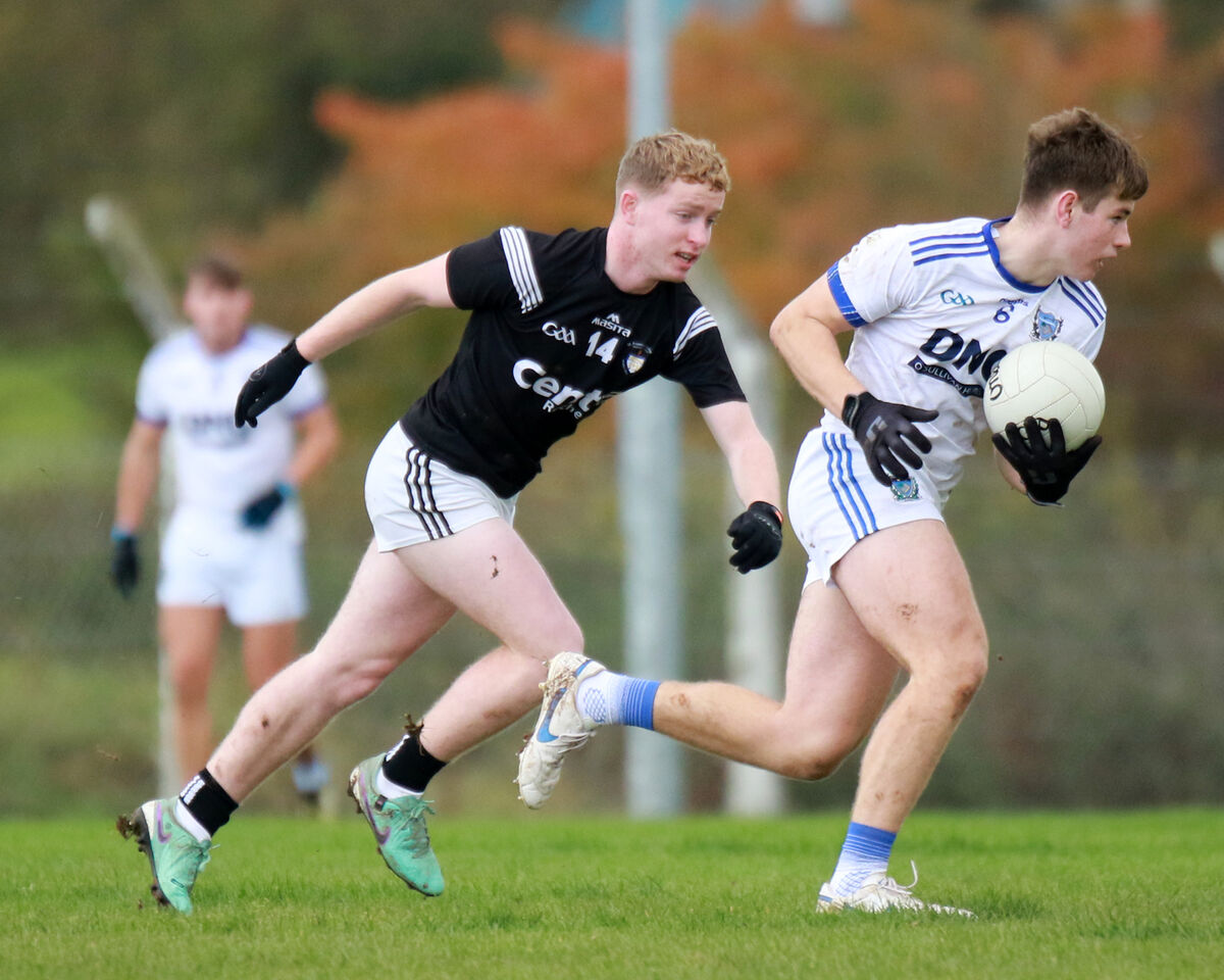 Neville O'Shea of St Flannan's breaks away from Harty O'Doherty.