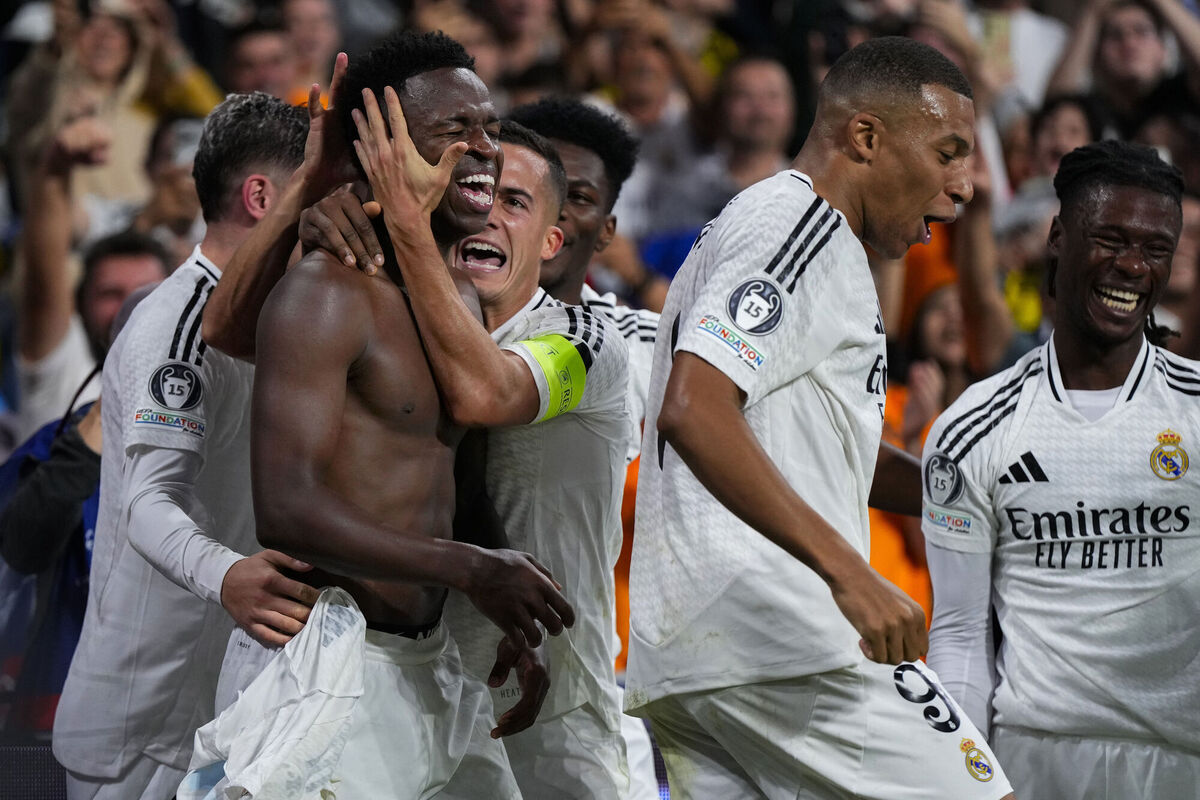 ON FIRE: Real Madrid's Vinicius Junior, left, celebrates with teammates after scoring his side's fourth goal during the Champions League opening phase soccer match between Real Madrid and Borussia Dortmund at the Santiago Bernabeu stadium in Madrid, Tuesday, Oct. 22, 2024. Real Madrid won 5-2. (AP Photo/Manu Fernandez)