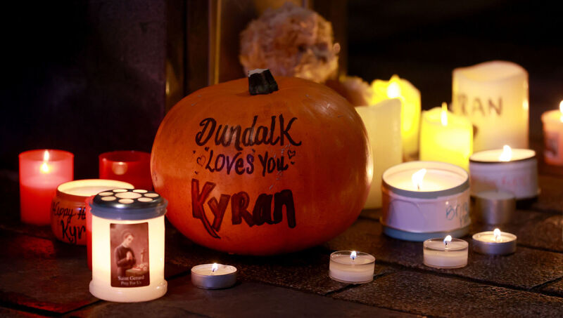 A pumpkin and candles among other tributes places during a vigil for Kyran Durnin in Market Square, Dundalk. Picture: Liam McBurney/PA