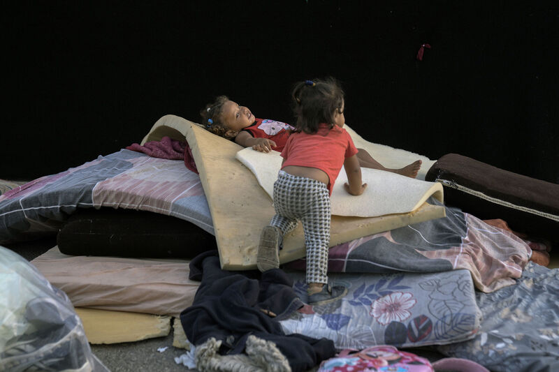 Children play next to their family's tent after fleeing the Israeli airstrikes in Dahiyeh, Beirut, Lebanon. Picture: AP/Bilal Hussein