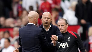 Arne Slot, right, shakes hands with Erik ten Hag after the Premier League match between Manchester United and Liverpool (Nick Potts/PA)