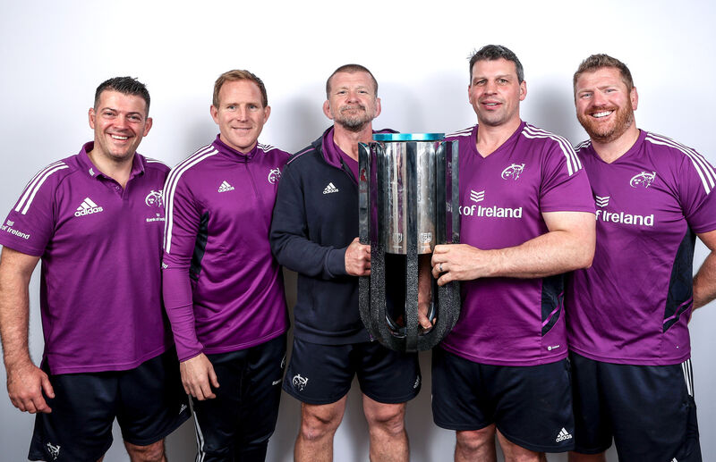 Munster’s lead performance analyst and technical coach George Murray, attack coach Mike Prendergast, hjead coach Graham Rowntree, defence Denis Leamy and forwards coach Andy Kyriacou celebrates with the URC Trophy. Pic: ©INPHO/James Crombie