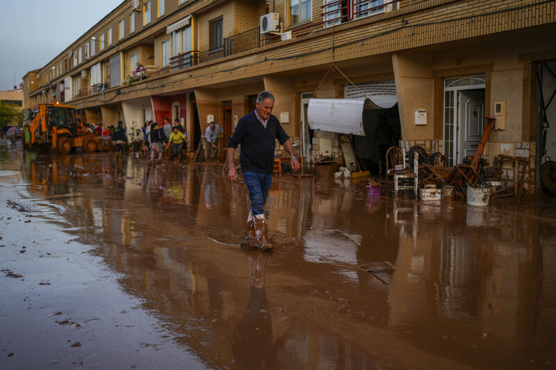 A man walks through floodwaters in Utiel, Spain, Wednesday, Oct. 30, 2024. (AP Photo/Manu Fernandez)