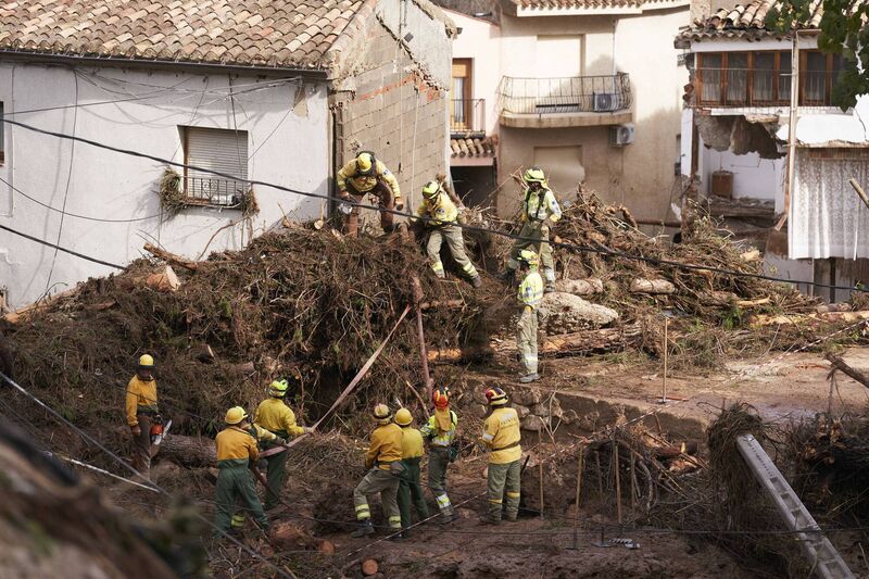Emergency workers clear debris after heavy rains hit the region on October 30. Picture: Mateo Villalba Sanchez/Getty Images
