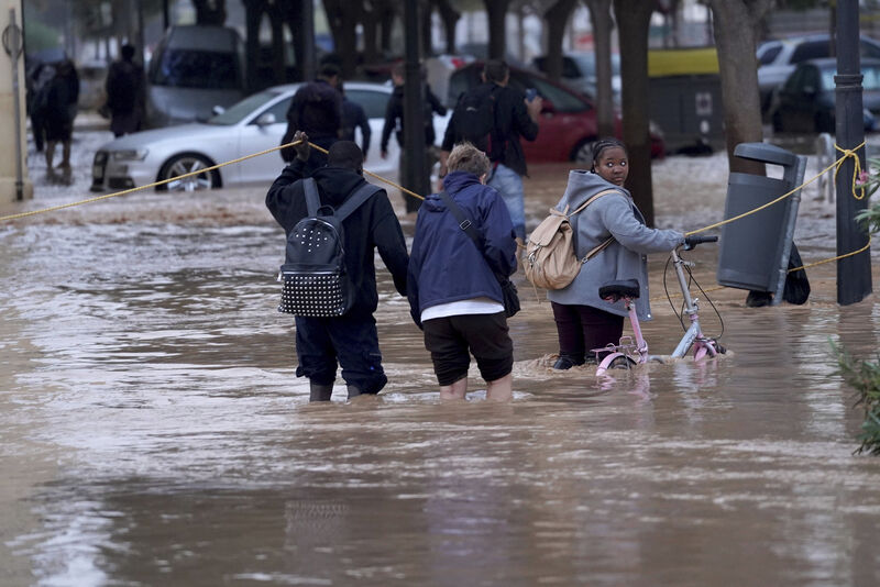 People walk through flooded streets in Valencia, Wednesday, October 30, 2024. People walk through flooded streets in Valencia, Wednesday, October 30, 2024.