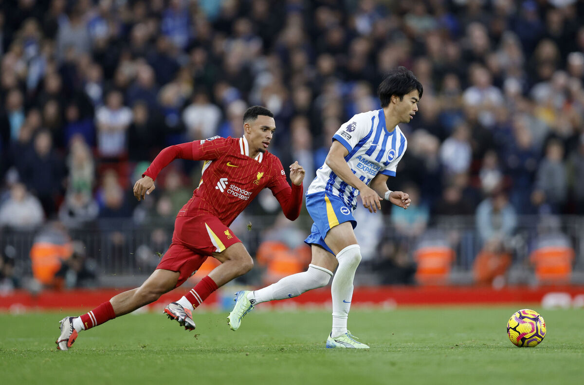 Brighton &amp; Hove Albion's Kaoru Mitoma (right) and Liverpool's Trent Alexander-Arnold (left) battle for the ball.