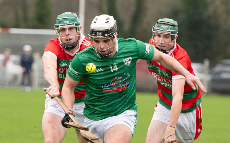 Killeagh's Barry Walsh breaks away from Carraig na bhFear's Felix Murphy and Jack Ahern. Pic: Howard Crowdy