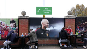 <p>Fans enjoy refreshments by a large photo of former Manchester United manager Erik ten Hag before the Premier League match at Old Trafford. Pic: Martin Rickett/PA Wire.</p>