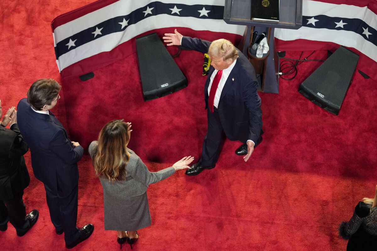 Republican presidential nominee former President Donald Trump walks over to hug former first lady Melania Trump as their son Barron Trump, left, watches while delivering remarks to supporters at an election night watch party Wednesday, Nov. 6, 2024, in West Palm Beach, Fla. Picture: AP Photo/Jeff Roberson