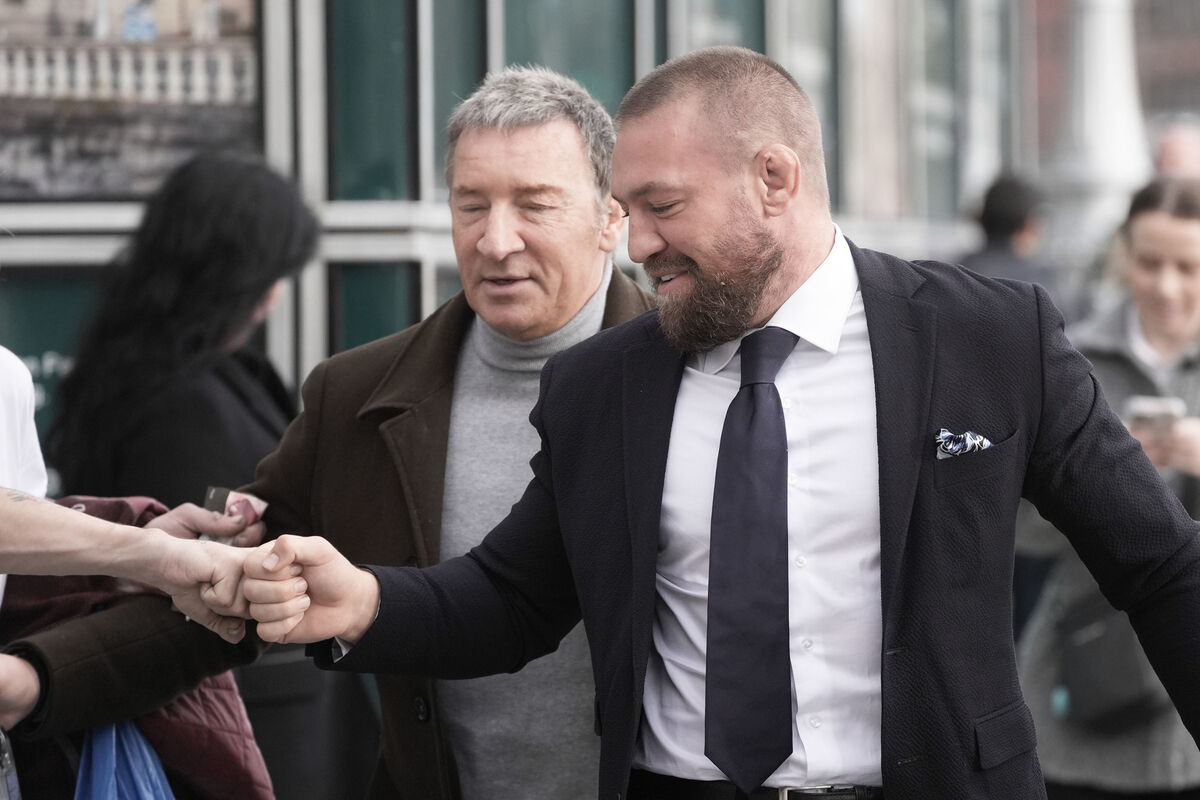 Conor McGregor (right) with his father Tony McGregor outside the High Court in Dublin on Wednesday. Photo: Niall Carson/PA