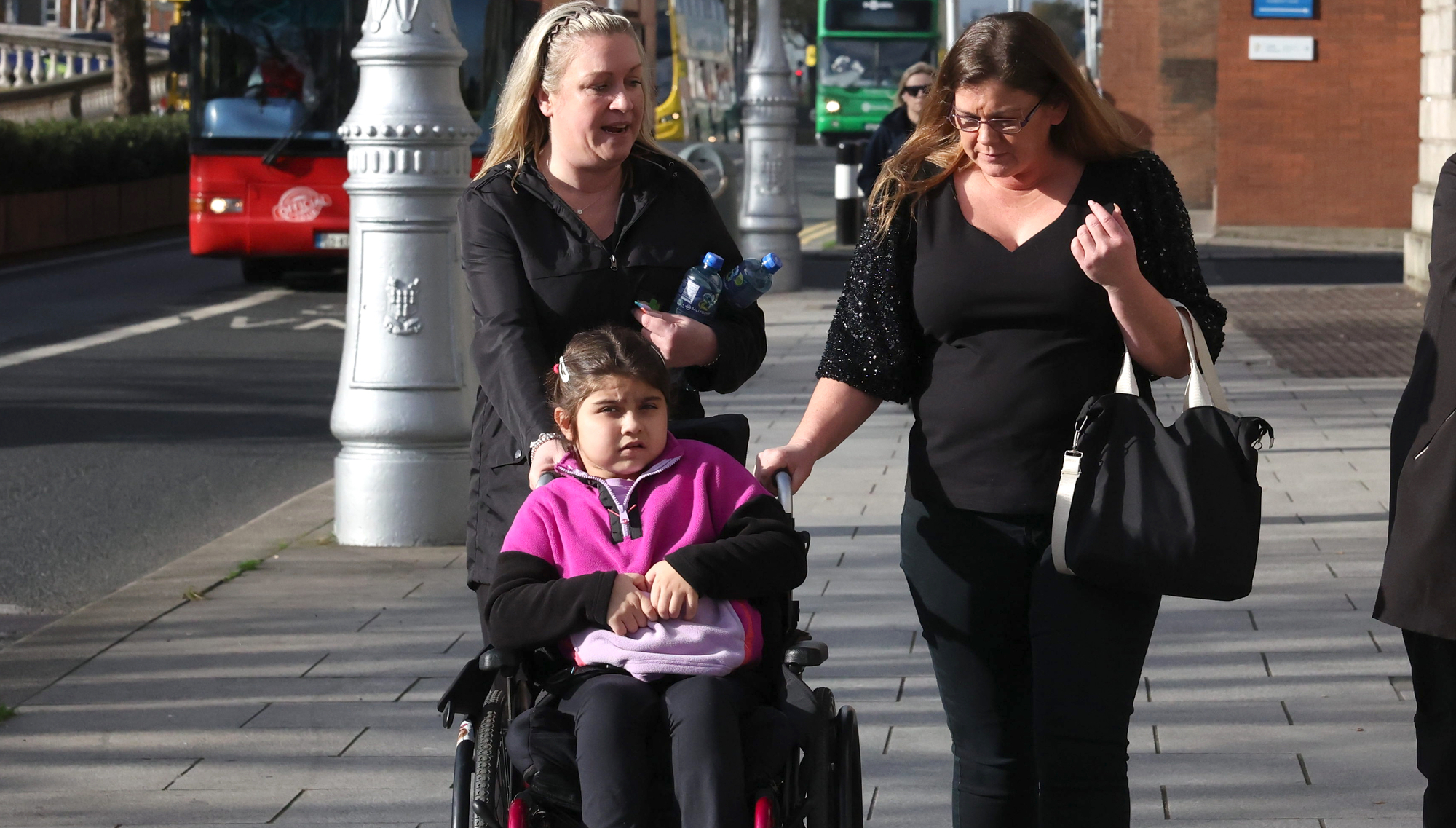 Amira O’Toole Rauf (centre), who settled an interim action over a car crash which left her paralysed, with her mother Caroline O’Toole Rauf (right) leaving the Hight Court in Dublin on Wednesday. Picture: Collins Courts