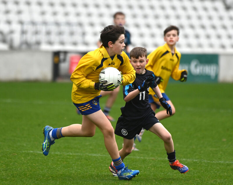  Dylon Hickey of Ballincurrig battles to keep possession from Danny O'Riordan of Saint John the Baptist NS.
