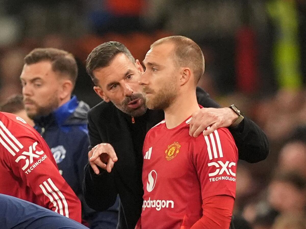 Interim manager Van Nistelrooy speaks to substitute Christian Eriksen on the touchline