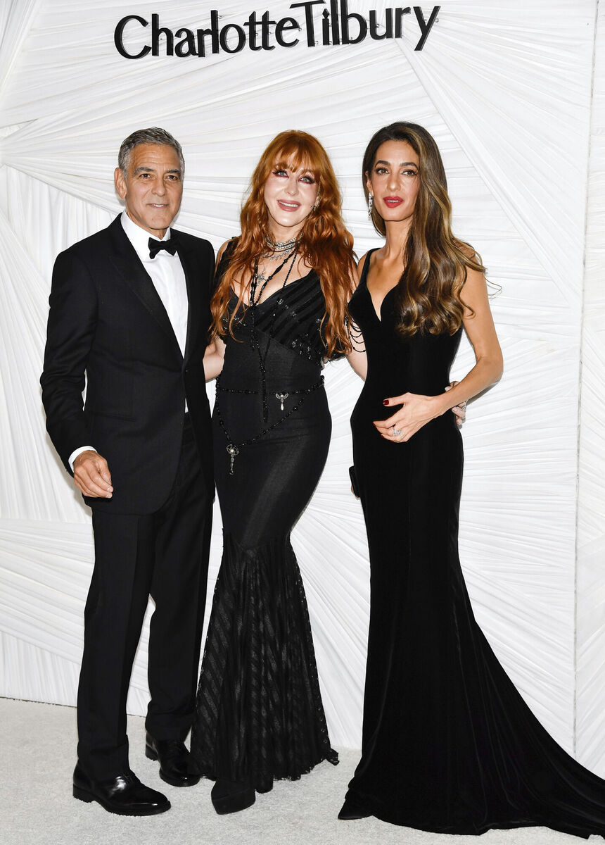 George Clooney, left, Charlotte Tilbury and Amal Clooney pose together at The Albies hosted by the Clooney Foundation for Justice at the New York Public Library on Thursday, Sept. 26, 2024, in New York. (Photo by Evan Agostini/Invision/AP)