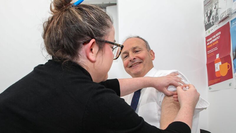 Tánaiste Micheál Martin receives a booster shot for covid from pharmacist Maura O'Donnell during a visit to Carrigtwohill Pharmacy in Co Cork. Picture: David Creedon