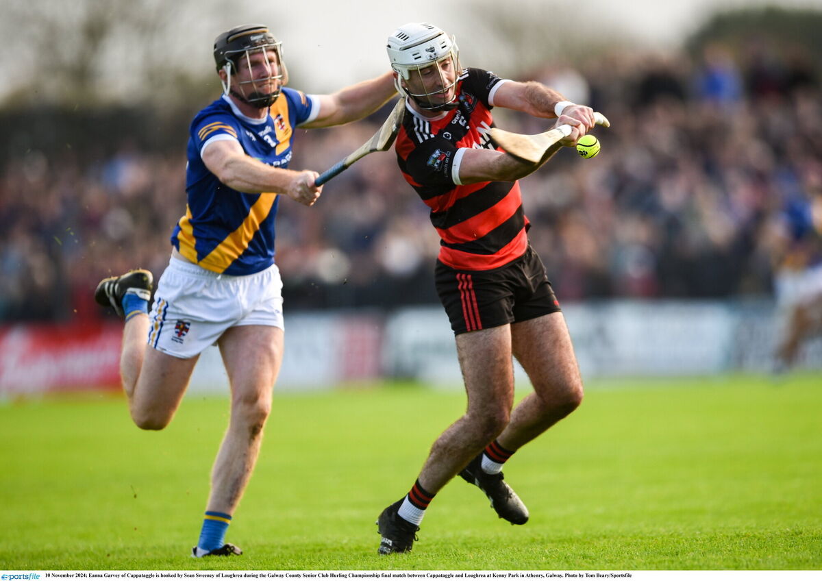 Eanna Garvey of Cappataggle is hooked by Sean Sweeney of Loughrea. Pic: Tom Beary/Sportsfile