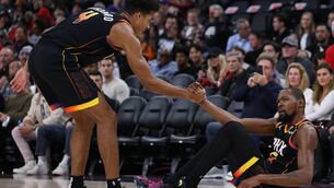 <p>Kevin Durant of the Phoenix Suns receives help getting up from Oso Ighodaro after a LA Clippers foul during a 125-119 Suns win at Intuit Dome on October 31, 2024 in Inglewood, California. (Photo by Harry How/Getty Images)</p>