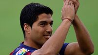 Suarez scores twice to open Barcelona account