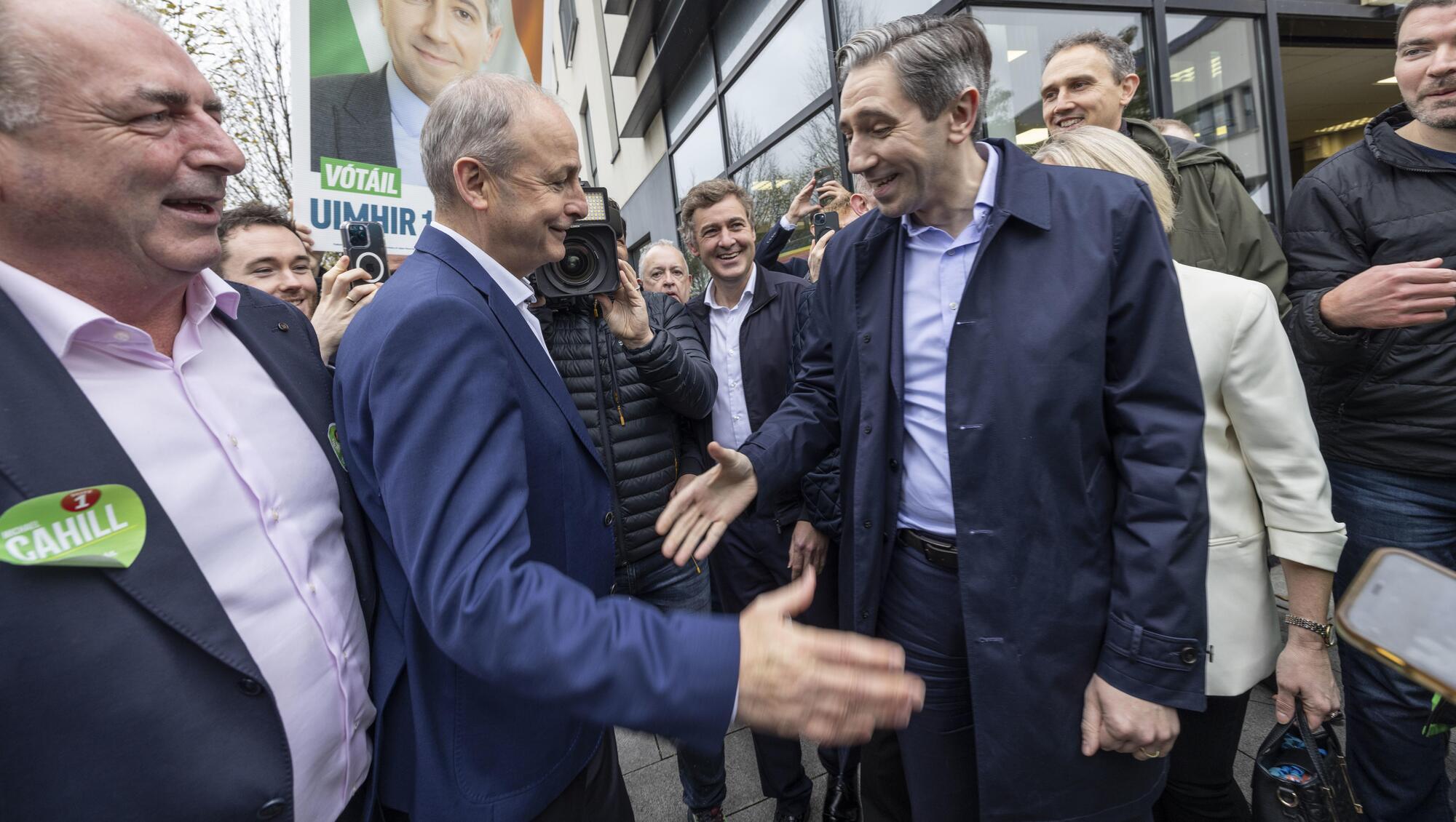 Simon Harris bounds from the bunker to greet Micheál Martin in their civil war