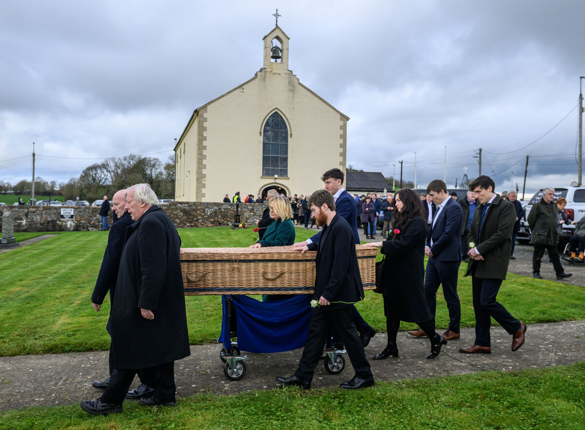  The coffin of the late Jon Kenny is escorted by his wife Mary, daughter Maya and son Aran and family and family members from St. Patrick's Church to the adjoining cemetery, Lough Gur, Bruff, Co Limerick. Picture Dan Linehan