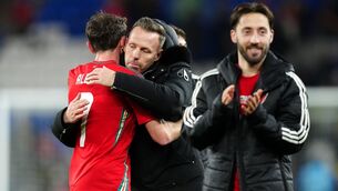 <p>GOING UP: Wales manager Craig Bellamy greets Joe Allen following their win over Iceland. Pic: David Davies/PA Wire.</p>