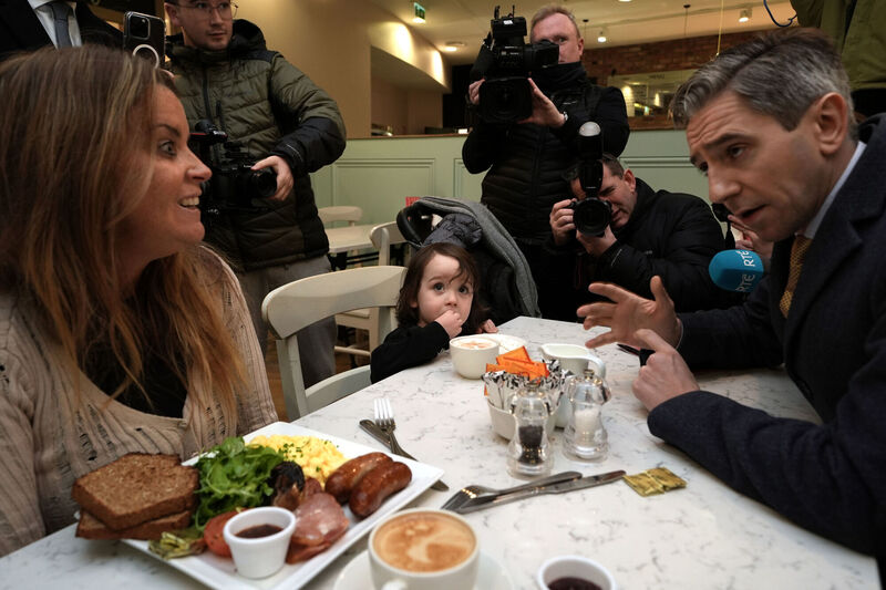 Taoiseach Simon Harris speaking to Helen Kennedy and her two-year-old son, Liam Fitzpatrick, while canvassing at Avoca in Malahide Castle, Dublin, ahead of the general election on November 29. Picture: Brian Lawless/PA