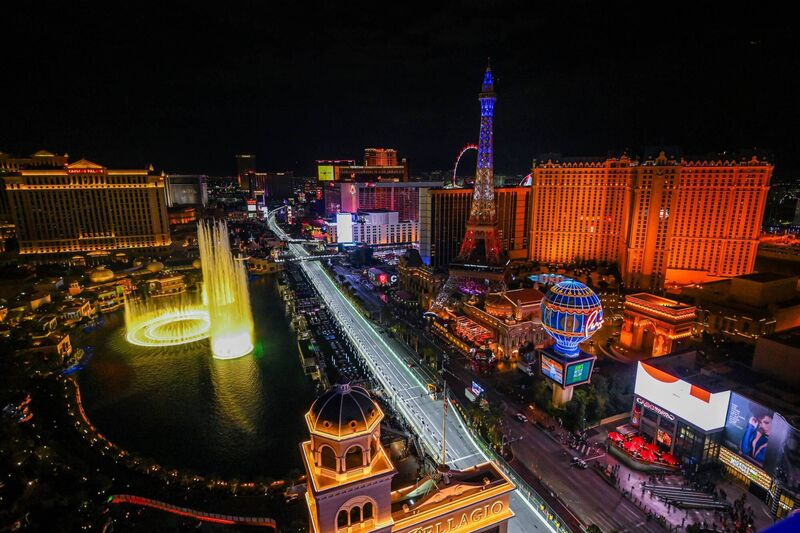 The Strip in Las Vegas, with the Fountains of Bellagio on left and Paris Las Vegas hotel on right, with its replica Eiffel Tower, Arc de Triomphe, and Montgolfier Balloon.