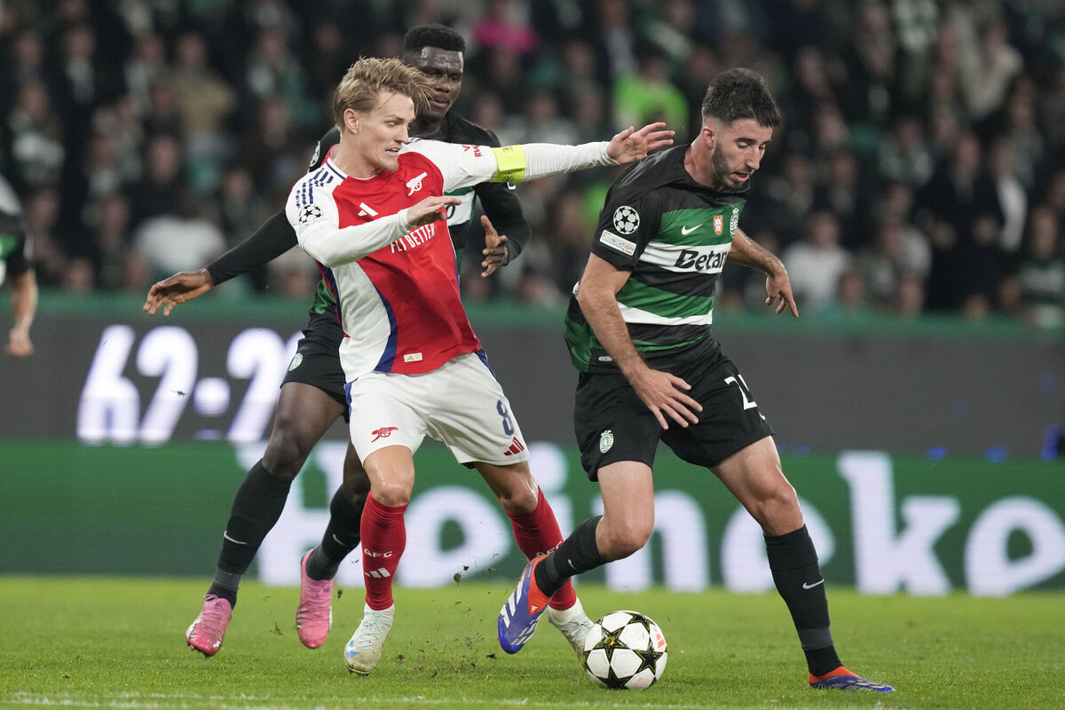 Arsenal's Martin Odegaard and Sporting's Goncalo Inacio fight for the ball. Pic credit: AP Photo/Armando Franca. Arsenal's Martin Odegaard and Sporting's Goncalo Inacio fight for the ball. Pic credit: AP Photo/Armando Franca.
