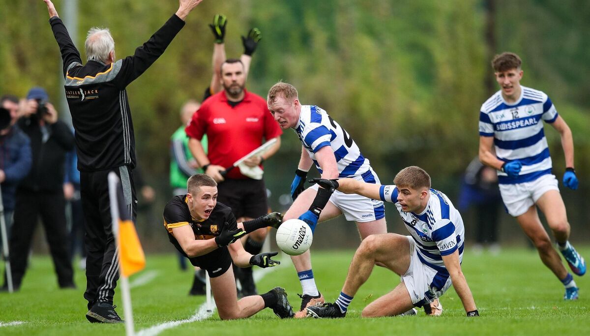 Evan Looney of Dr Crokes in action against David Whelton, and Andrew Whelton of Castlehaven. Picture: Michael P Ryan/Sportsfile