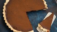 chocolate and caramel tart on dark blue background