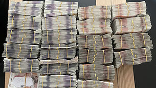 <p>Bundles of banknotes seized by Britain's National Crime Agency as it and other international agencies brought down a multibillion-dollar money laundering network run by two Russian millionaires. Picture: National Crime Agency/PA</p>