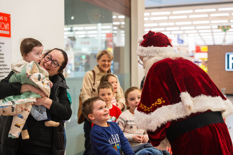 Baby Fionn Ryan, seven months, his big brother Jack and cousin Aoibhe Horgan, five, are greeted by Geno as Santa. Picture: Noel Sweeney Baby Fionn Ryan, seven months, his big brother Jack and cousin Aoibhe Horgan, five, are greeted by Geno as Santa. Picture: Noel Sweeney