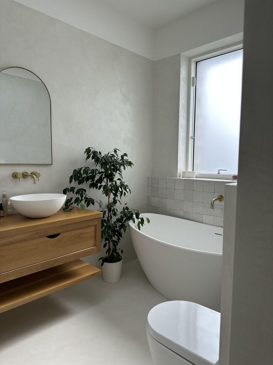  Anna Bougharbel's own bathroom shows her micro-cement work with curvy sanitary ware and wooden accents for an inviting look.