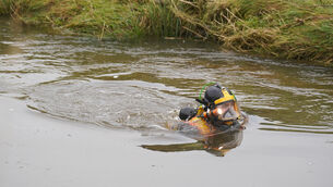 <p>Divers searching the water at Abberwick Ford on the River Aln near Alnwick. Picture: Owen Humphreys/PA</p>