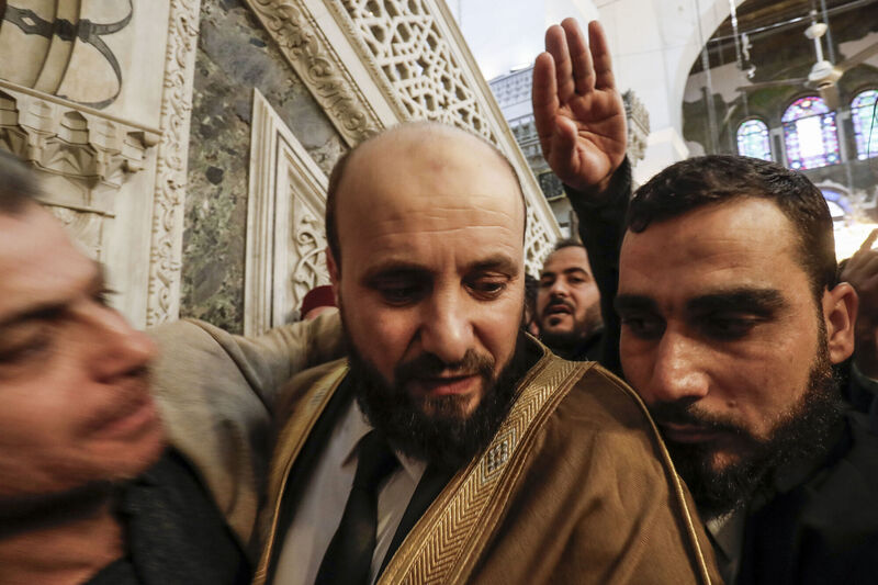 Mohammad al-Bashir, centre, the head of the interim government in Syria, attending Friday prayer inside the seventh century Umayyad mosque in Damascus, Syria, last night. Picture: Omar Sanadiki/AP Mohammad al-Bashir, centre, the head of the interim government in Syria, attending Friday prayer inside the seventh century Umayyad mosque in Damascus, Syria, last night. Picture: Omar Sanadiki/AP