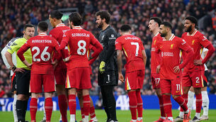 <p>RED ALERT: Liverpool players protest as referee Tony Harrington gives a red card to Andy Robertson. Pic: Peter Byrne/PA Wire.</p>