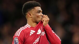 <p>DIALLO DELIGHT: Manchester United's Amad Diallo kisses the badge as he celebrates scoring their side's winner. Pic: Martin Rickett/PA Wire.</p>