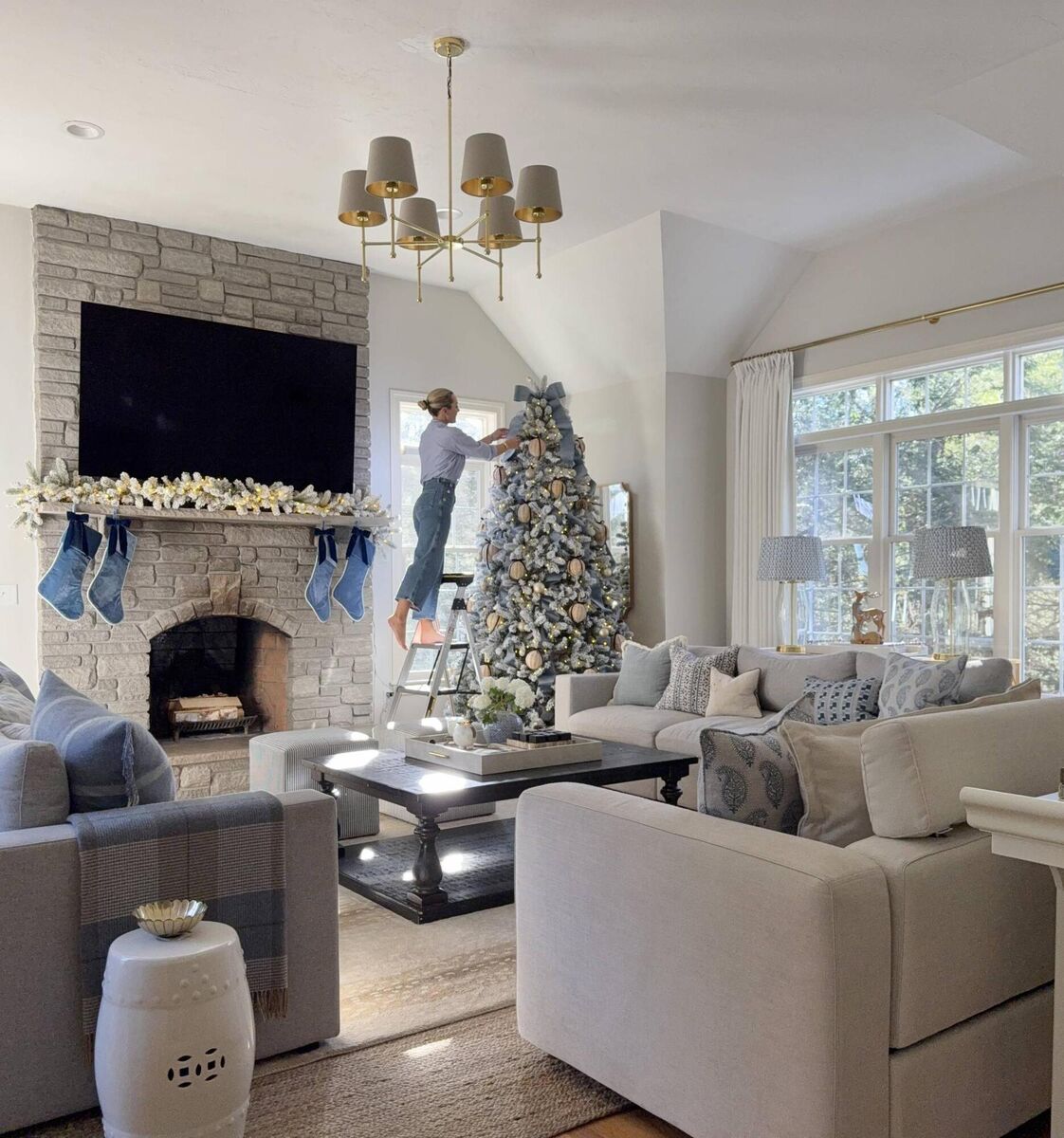 Phoebe puts up her flocked tree in the family room. 