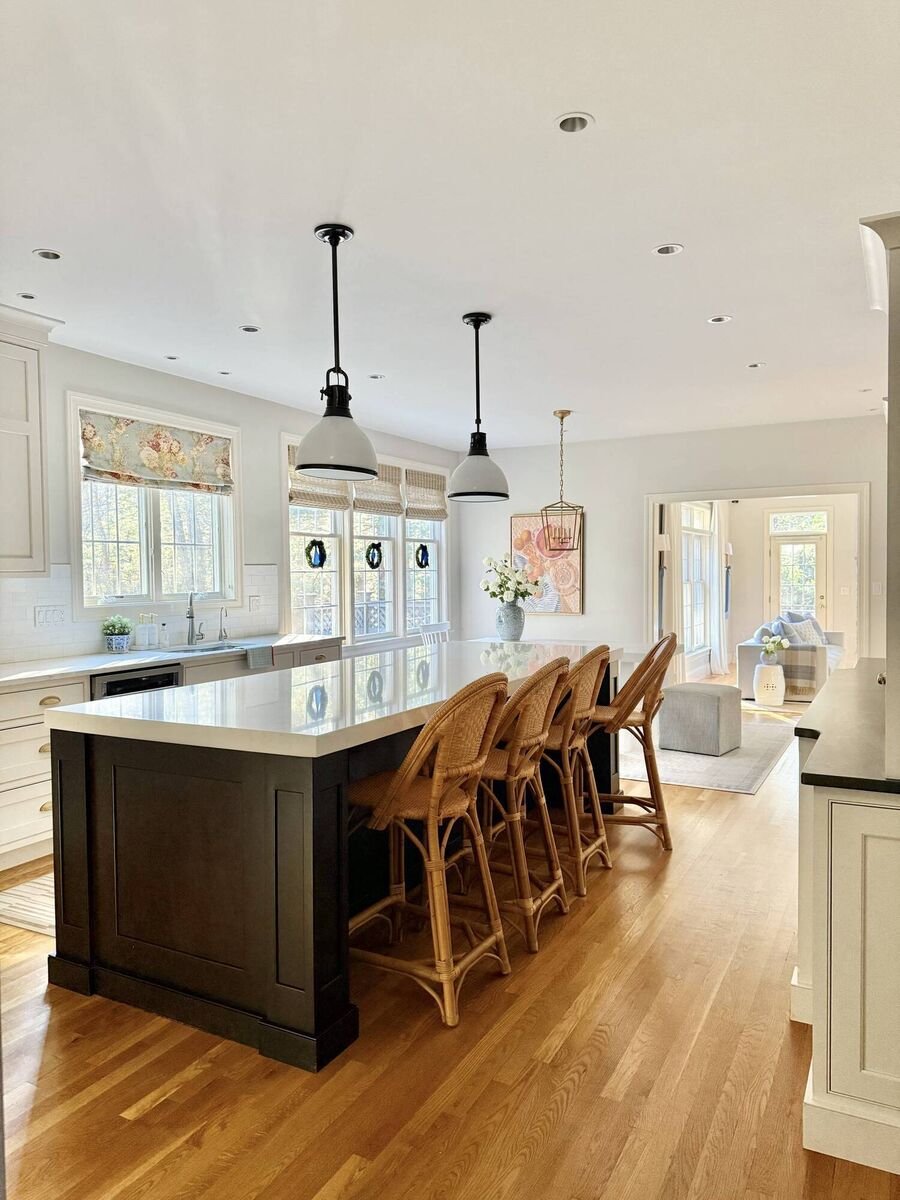 The kitchen, complete with Serena &amp; Lily counter stools, Phoebe's 'buy of the season', at the kitchen island and mini-wreaths adorning the windows.