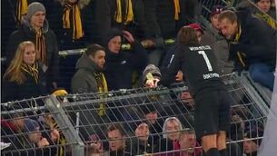 Players scale fences to talk to fans as Dortmund hit bottom