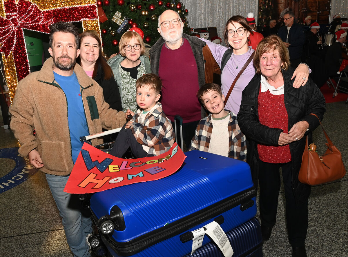 'Fair play to Cork Airport — the orchestra, the decorations, it’s incredible'. Meadhbh Ní Callanáin and John Riordan with their boys Oisin and Tadhg were welcomed home from Melbourne by family members at Cork Airport. Pictures: Larry Cummins